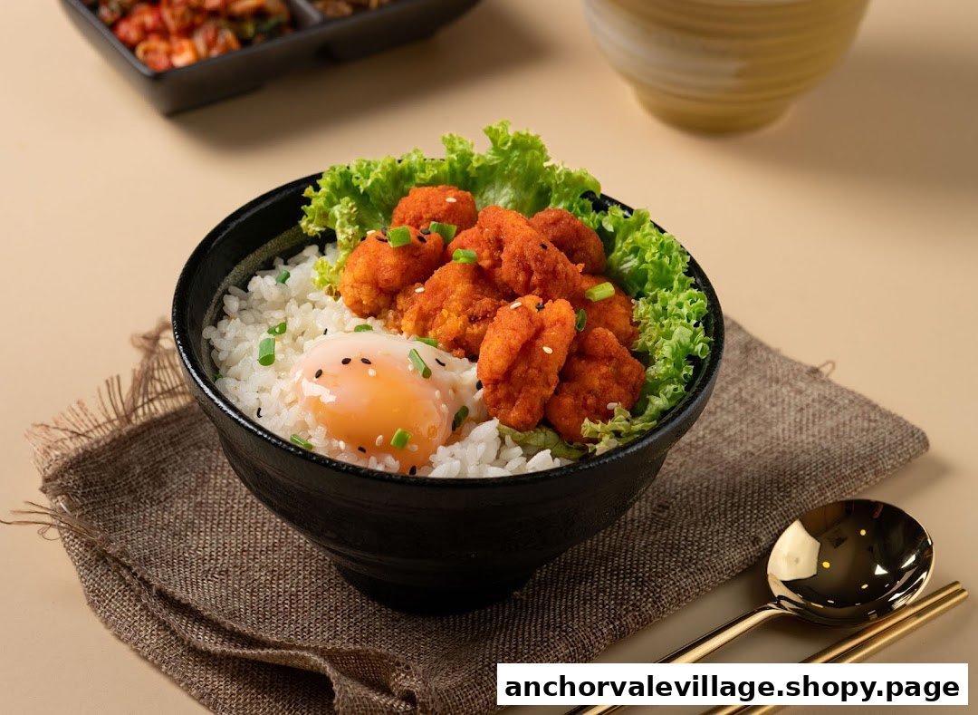 A vibrant bowl of crispy fried chicken, fresh lettuce, and a soft-boiled egg over rice.