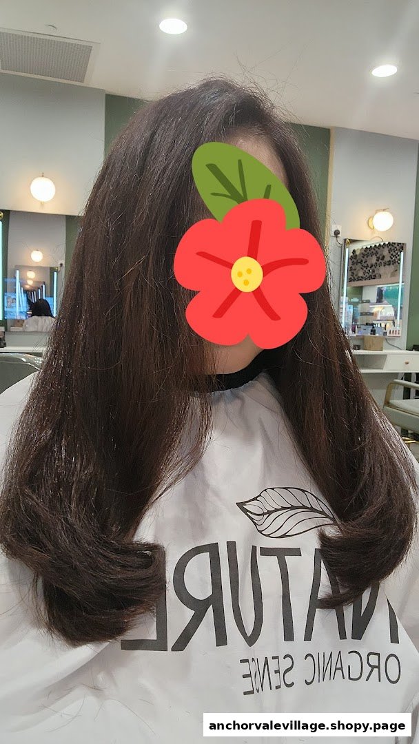 A client showcasing long, dark, healthy hair after a treatment at Organic Express Hair Color Lab.