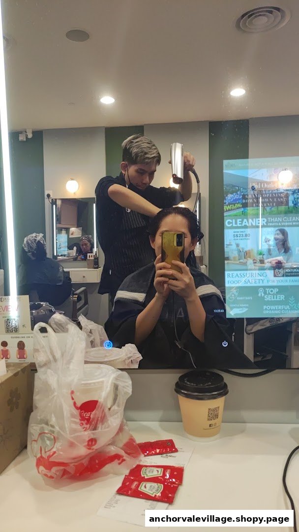 A customer receives a hair treatment from a stylist inside Organic Express Hair Color Lab.