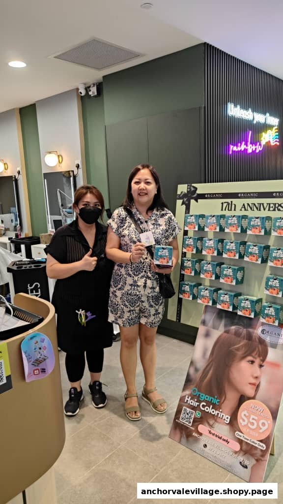 Two women, one staff and one customer, pose inside Organic Express Hair Color Lab with product displays.