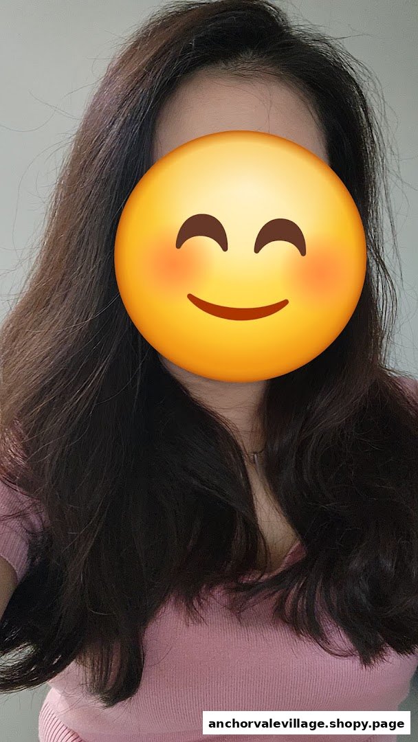 A person showcasing long, dark, healthy-looking hair, likely a result of a hair treatment.
