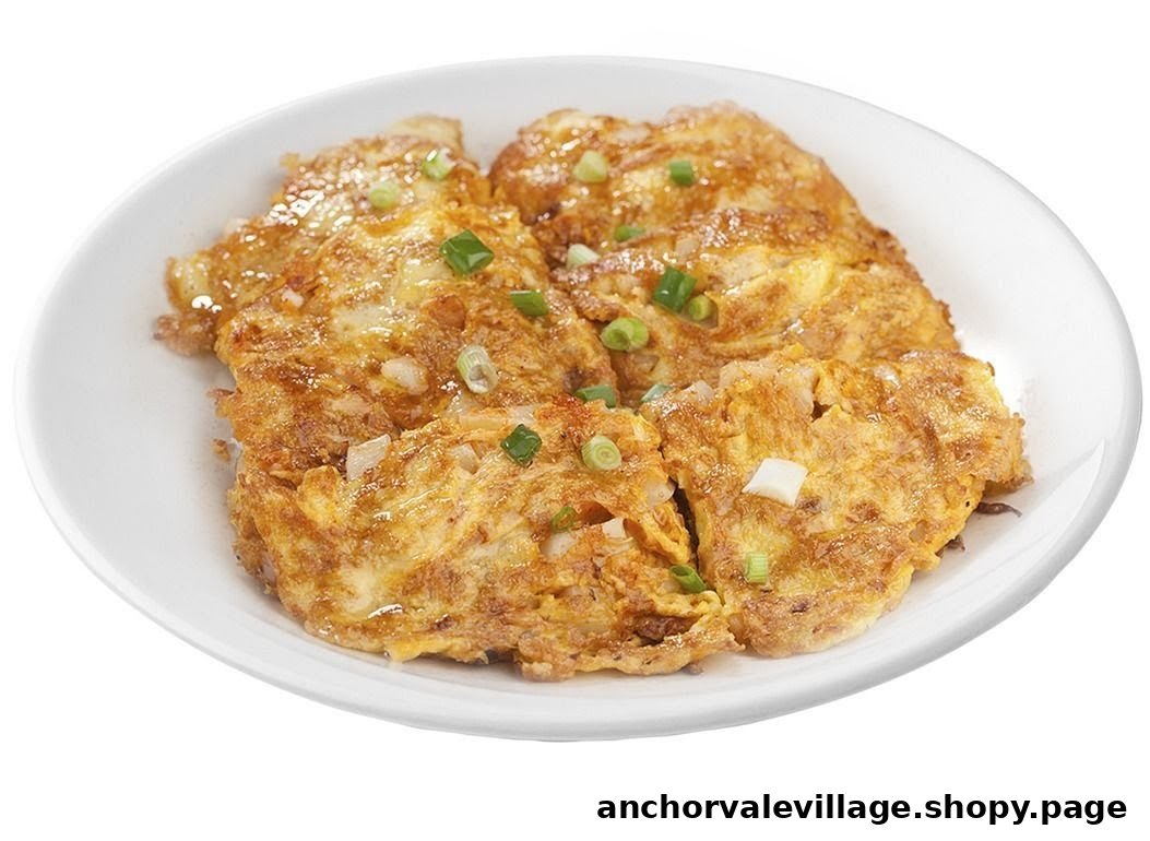 A plate of golden-brown fried omelets garnished with chopped spring onions.