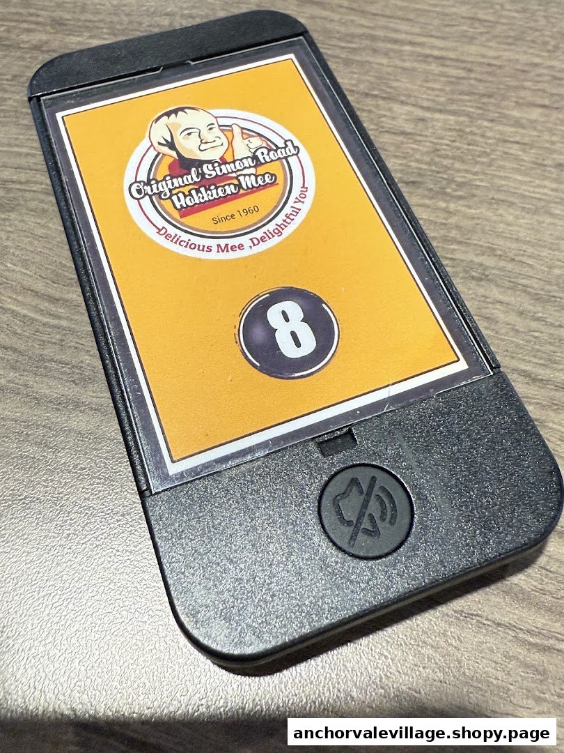 A restaurant pager displaying the Original Simon Road Hokkien Mee logo and order number 8.