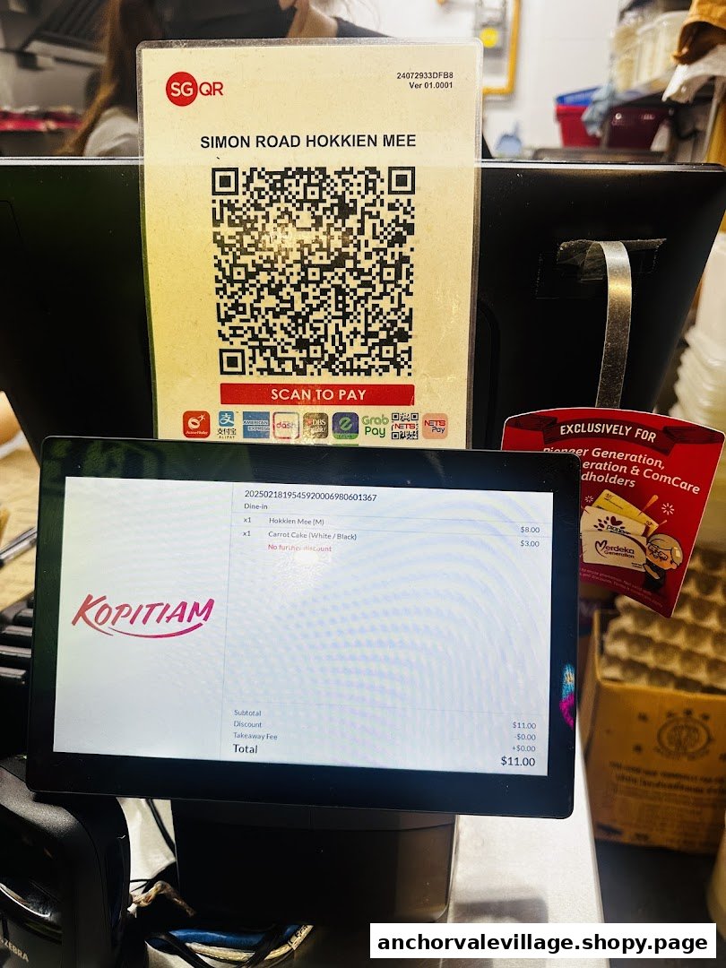 A payment counter displaying a QR code for 'Simon Road Hokkien Mee' and a digital order screen.