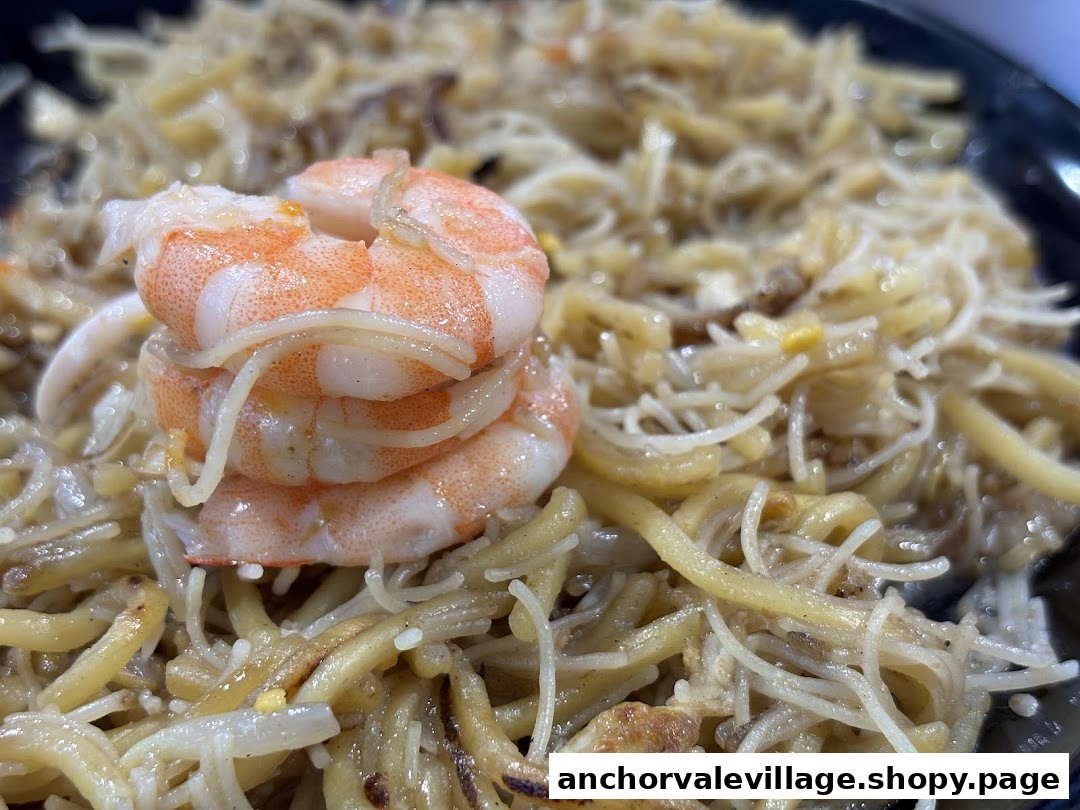 A close-up of Original Simon Road Hokkien Mee, featuring noodles and succulent prawns.