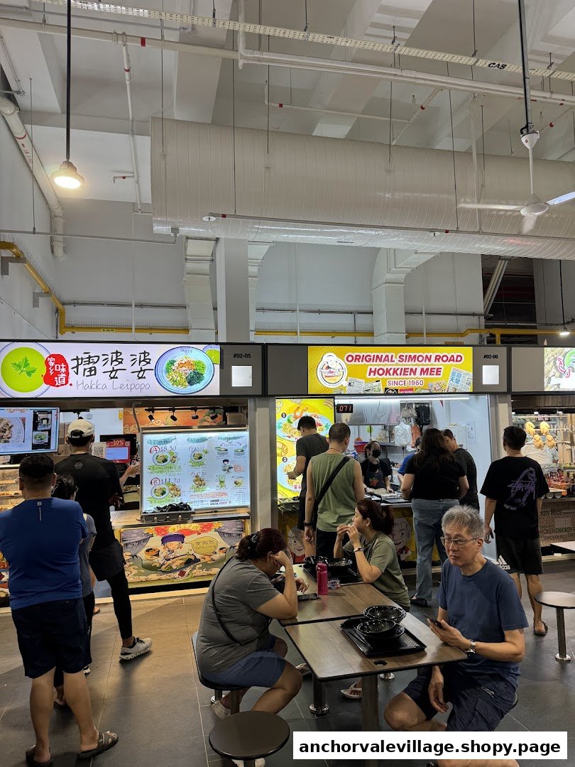 Diners enjoy meals at a bustling food court featuring Original Simon Road Hokkien Mee and other stalls.