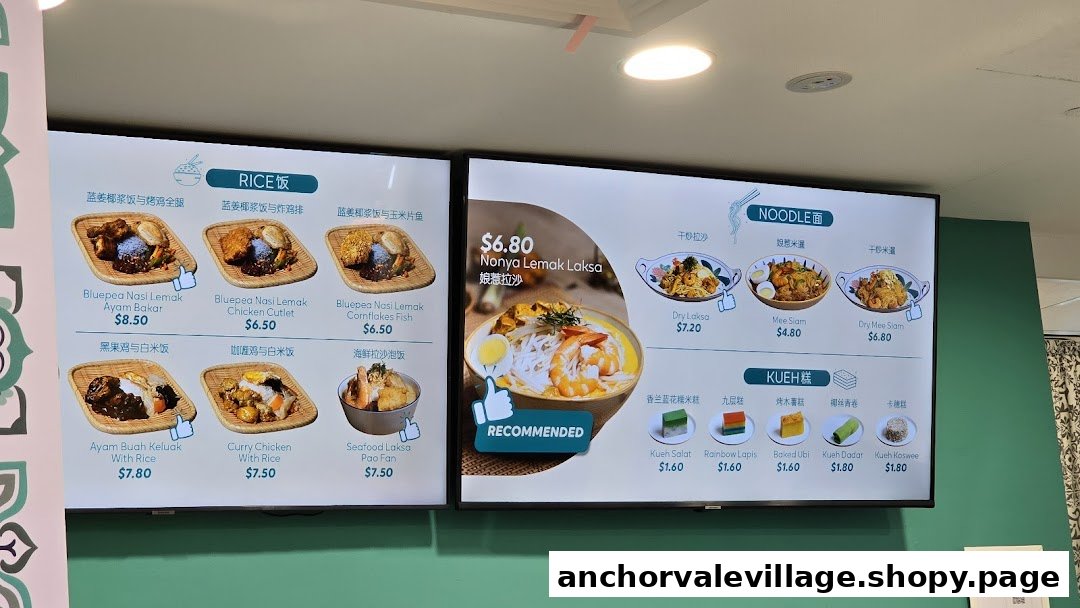 Digital menu boards displaying various rice, noodle, and kueh dishes with prices.