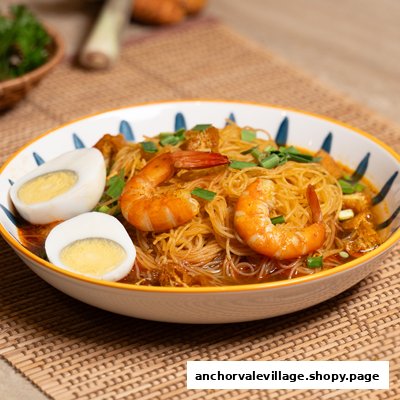 A vibrant bowl of curry noodles with prawns, boiled eggs, and spring onions.