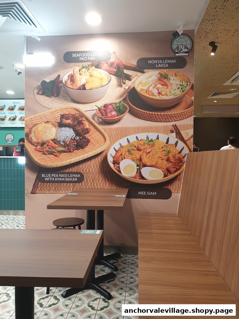 An interior view of Rempah by Chilli Padi, featuring large wall graphics of popular dishes and dining tables.