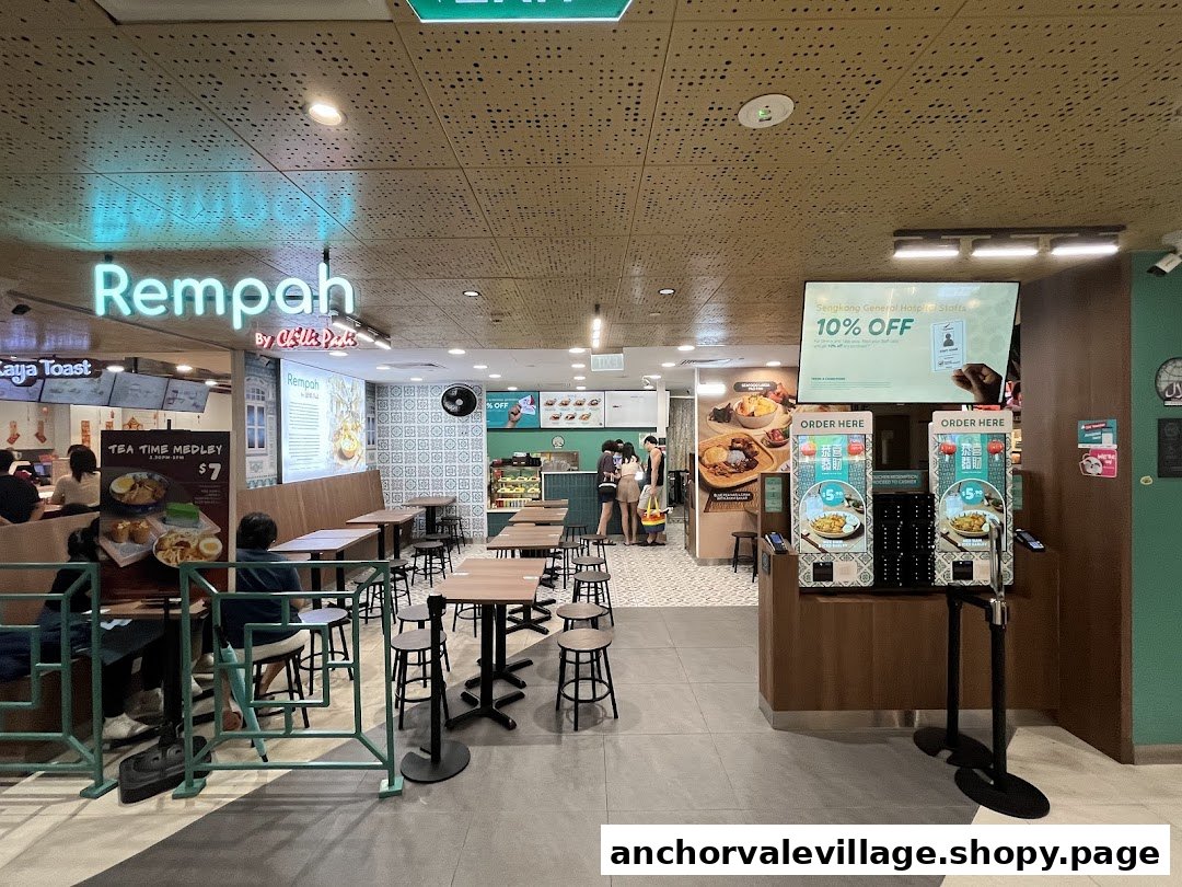 Interior view of Rempah by Chilli Padi, featuring seating, ordering kiosks, and a staff discount display.