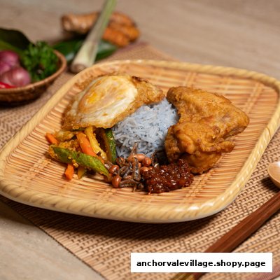 A vibrant plate of Nasi Lemak with blue pea rice, fried chicken, and a sunny-side up egg.