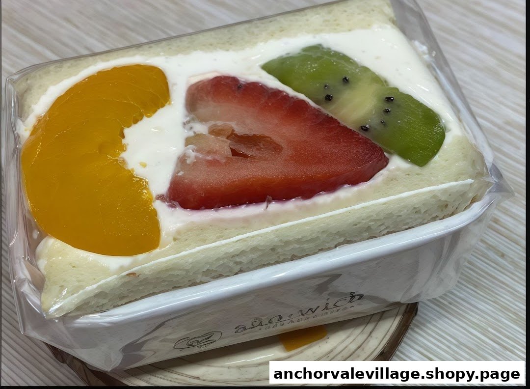 A delightful fruit sandwich featuring fresh peach, strawberry, and kiwi with cream filling.