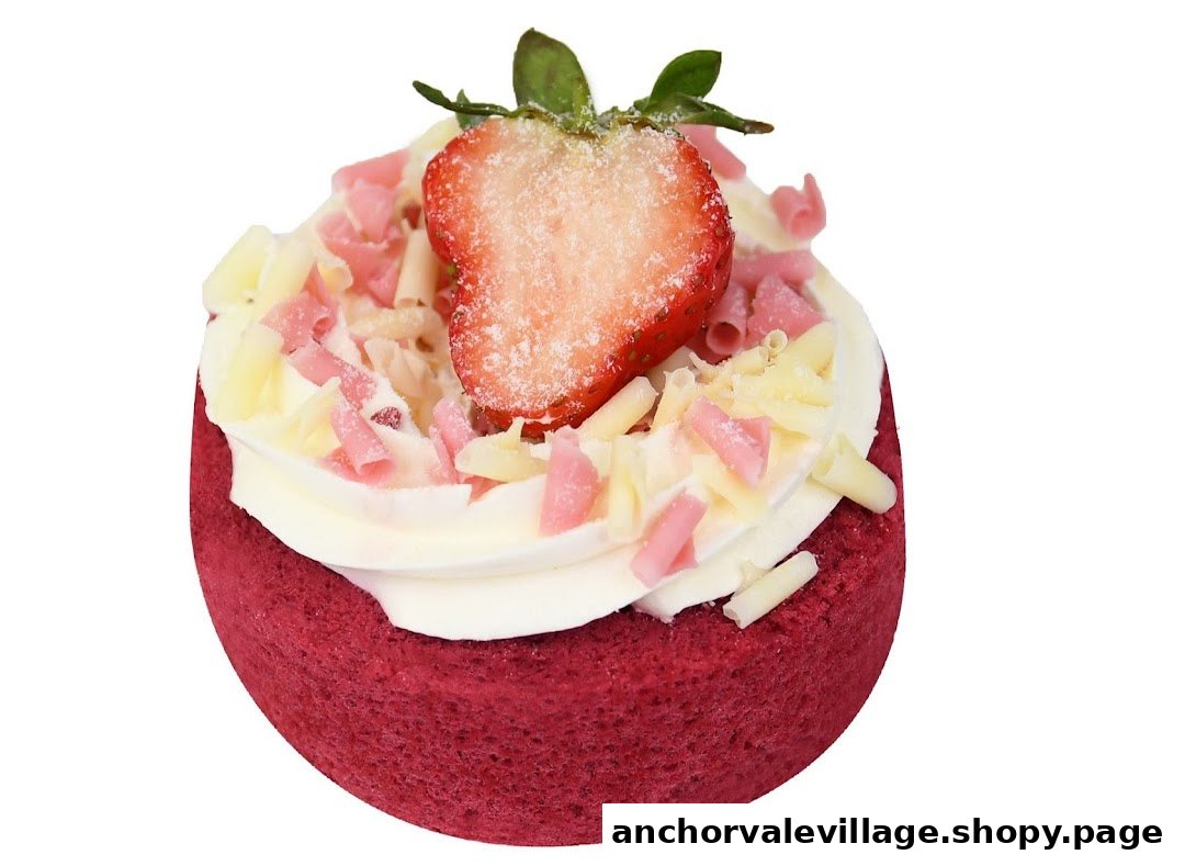 A vibrant red velvet tart topped with white cream, chocolate shavings, and a fresh strawberry half.