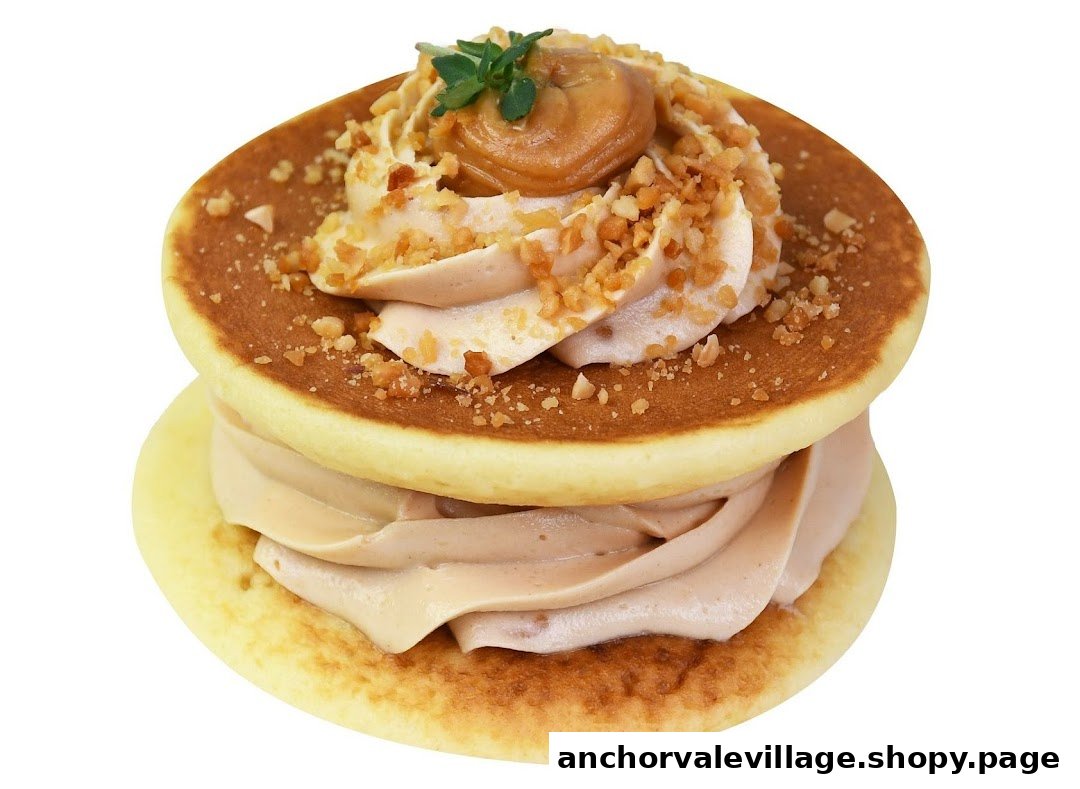A close-up of a fluffy pancake sandwich filled with cream, nuts, and a dollop of caramel.