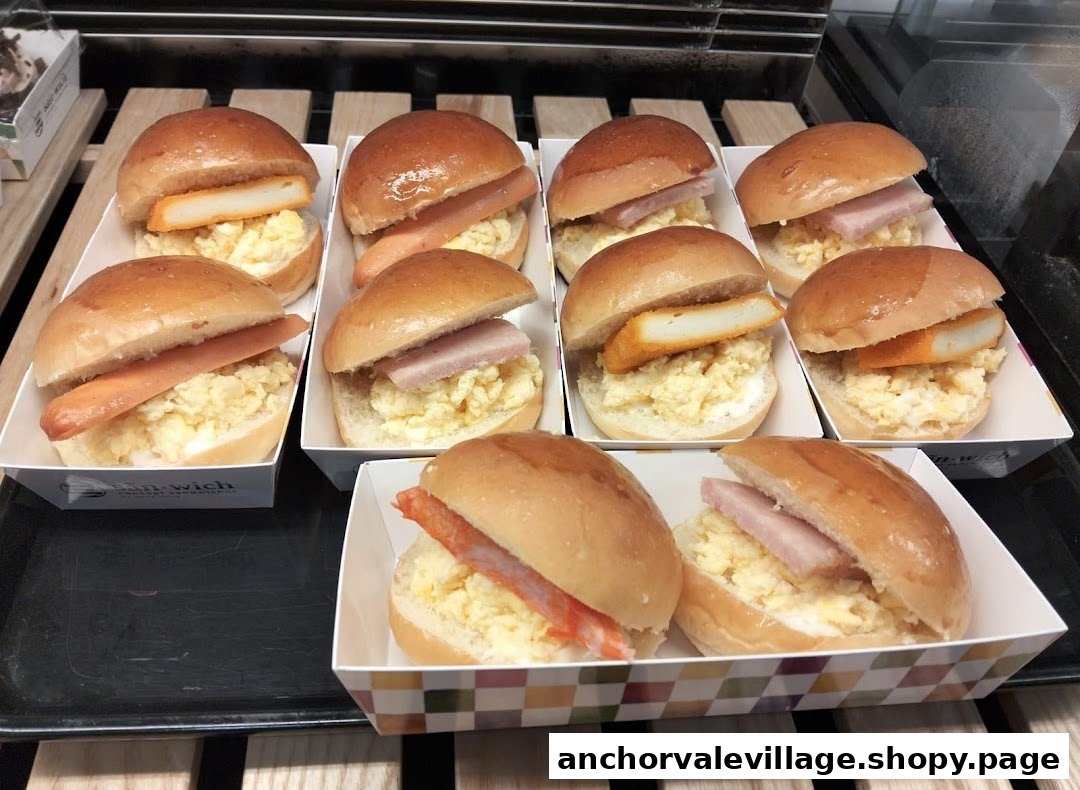 A display of mini sandwiches with scrambled egg and various toppings like sausage, ham, and fish cake.