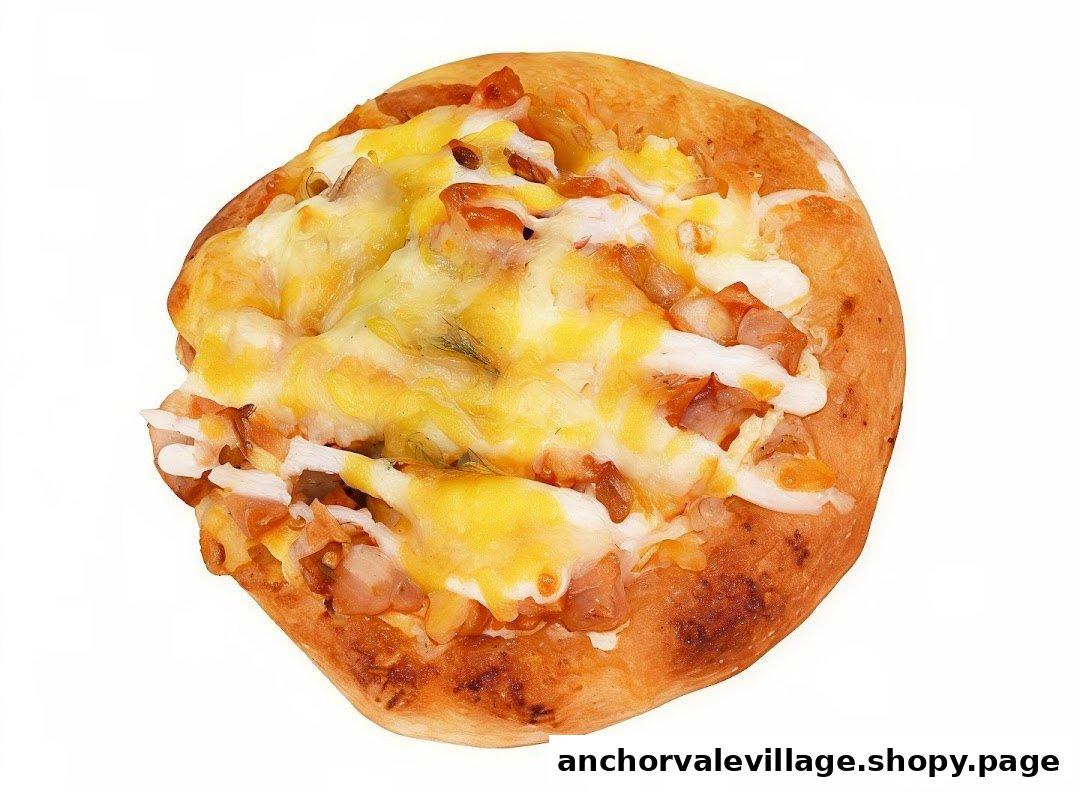 A close-up of a golden-baked savory bun topped with melted cheese and various ingredients.