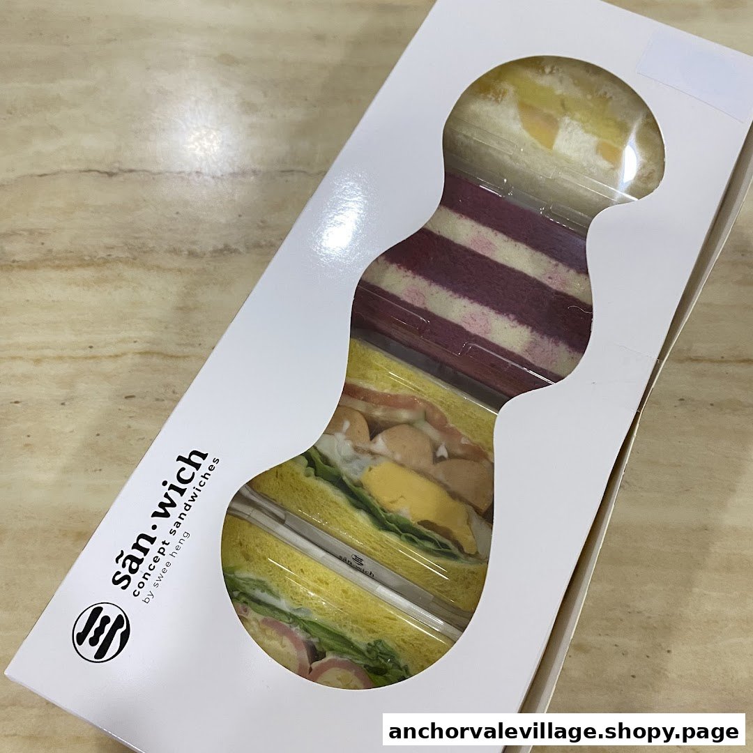 A white box showcasing colorful concept sandwiches from San.wich by Swee Heng, featuring various fillings and bread types.