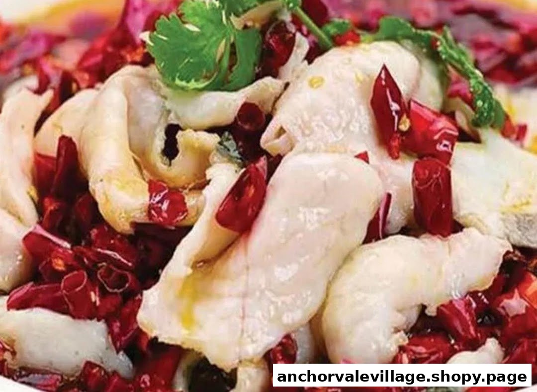 A close-up of tender fish fillets generously topped with vibrant red chilies and fresh cilantro.