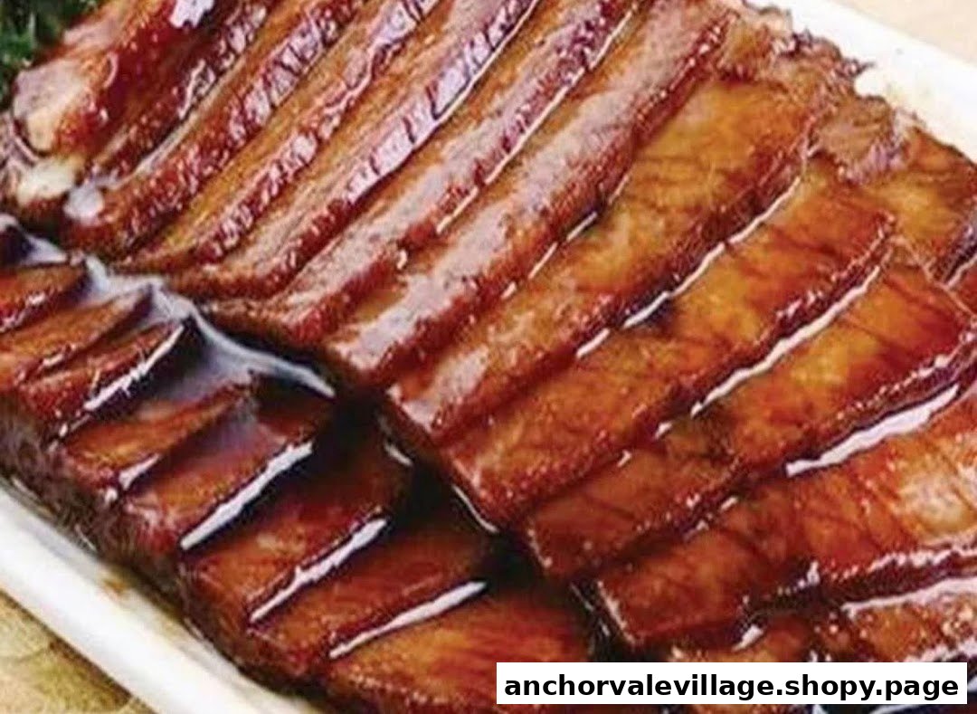 Close-up of glistening, savory meat slices, likely a grilled or braised dish.