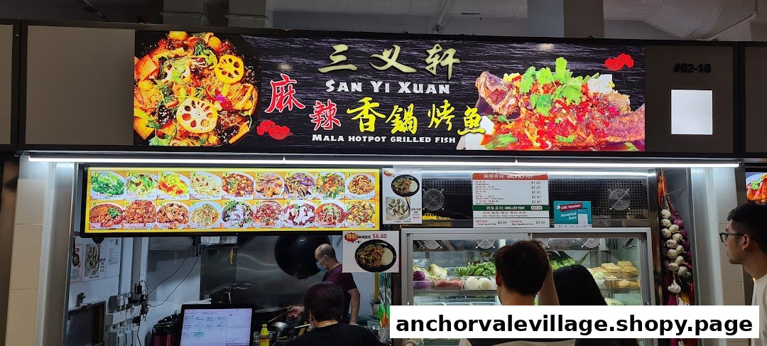 A bustling counter at San Yi Xuan Mala Hotpot Grilled Fish, showcasing vibrant dishes and customer service.