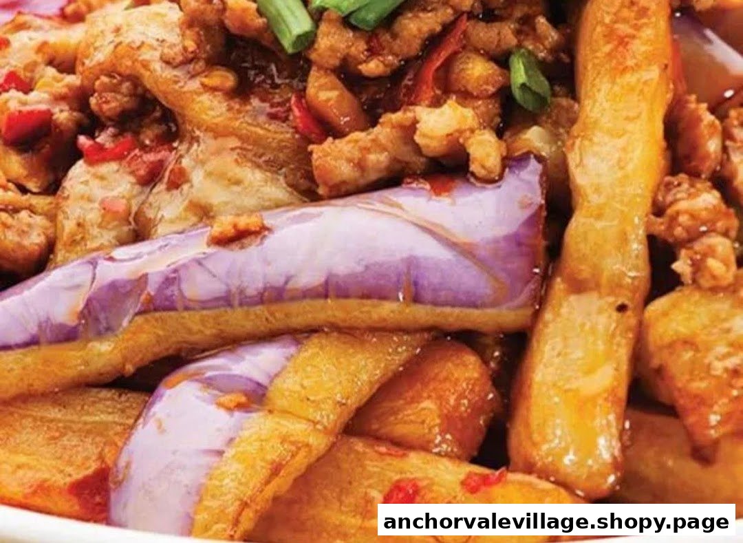 A close-up of a savory dish featuring tender eggplant, golden potatoes, and minced meat with chili and green onions.