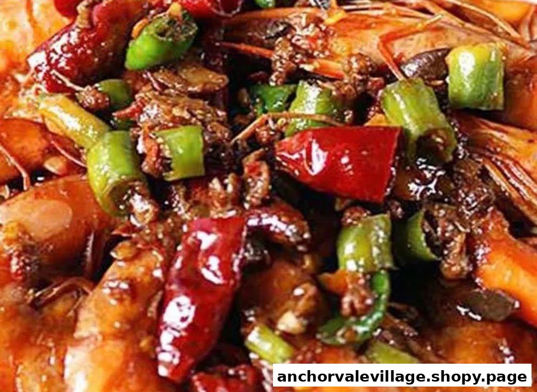 A close-up of a vibrant, spicy dish featuring prawns, red and green peppers in a rich sauce.