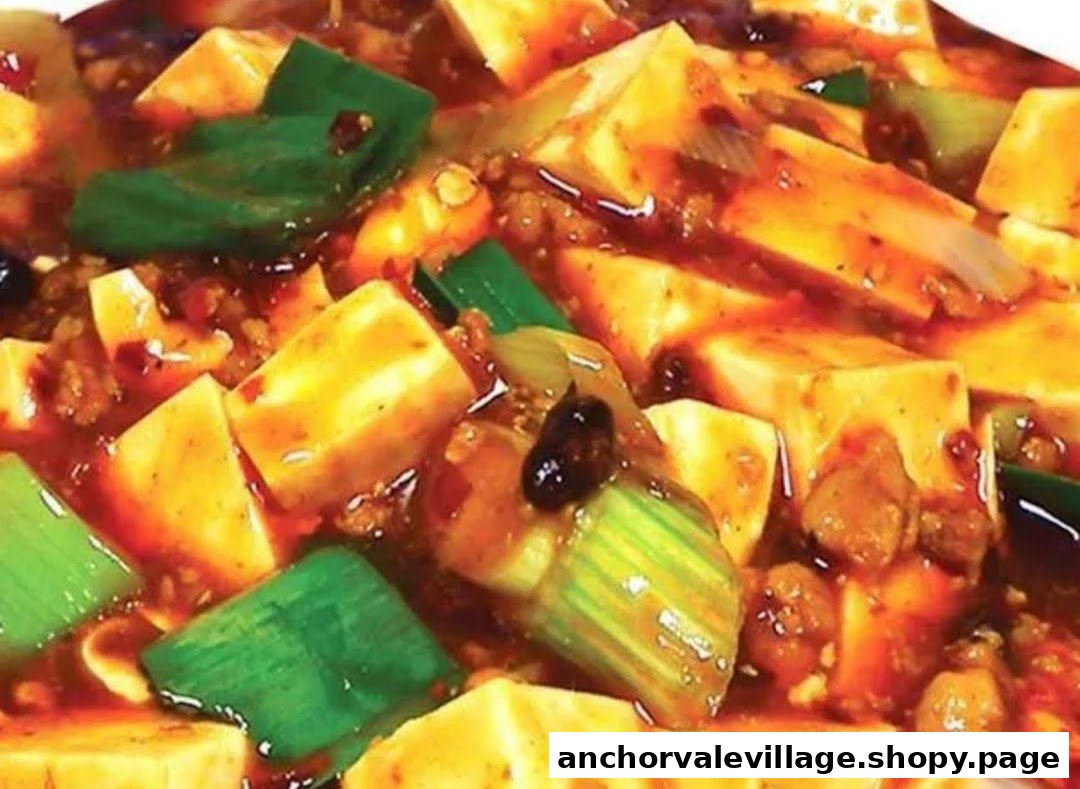 A close-up of a vibrant, spicy tofu dish with green vegetables and minced meat.