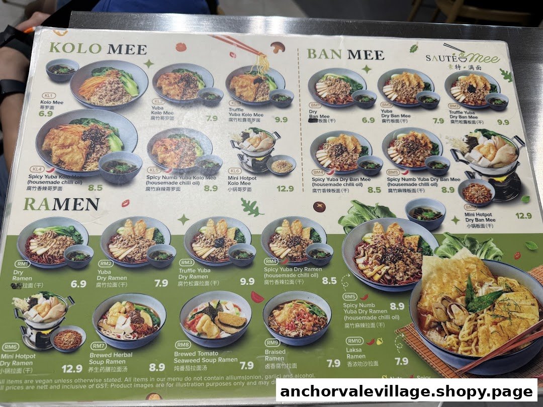 A detailed menu board displaying various vegan and vegetarian noodle dishes with prices and images.