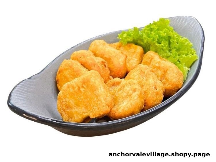 A bowl of golden-brown vegetarian nuggets served with fresh green lettuce.