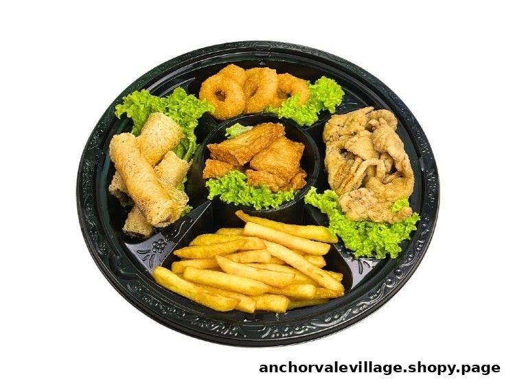 A black platter filled with assorted fried vegetarian snacks, including spring rolls, fries, and onion rings.