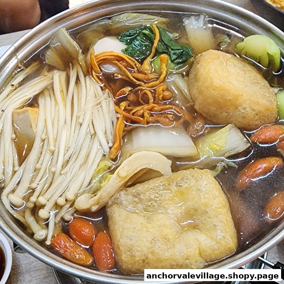 A close-up of a simmering hotpot filled with mushrooms, vegetables, and tofu.
