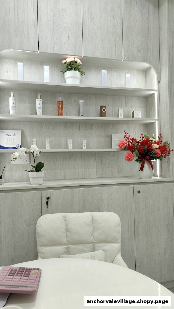 Interior view of a modern beauty shop featuring skincare products on illuminated shelves and a clean desk area.