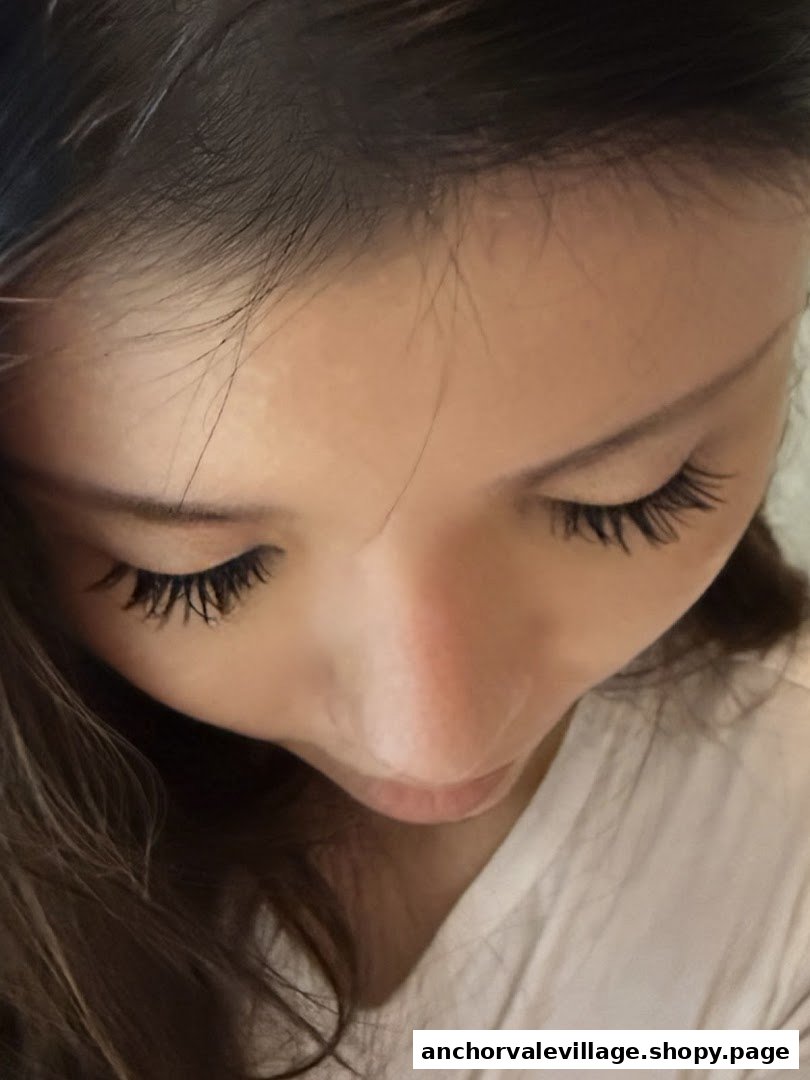 Close-up of a person's face showcasing beautifully enhanced eyelashes, likely after a beauty treatment.