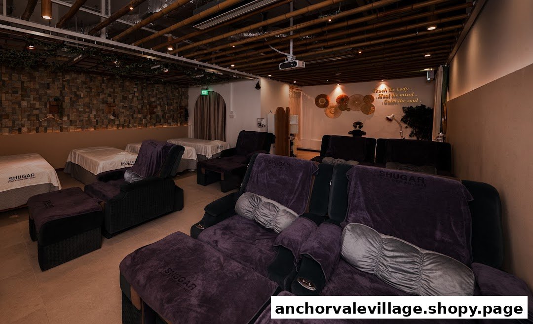 A serene interior of Shugar Foot & Body Wellness with comfortable massage chairs and beds.
