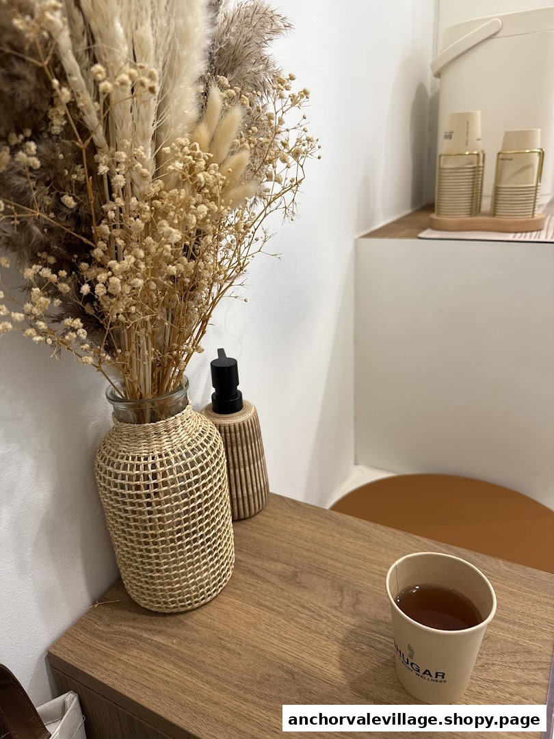 A warm cup of tea and natural decor on a wooden surface, reflecting a serene wellness environment.