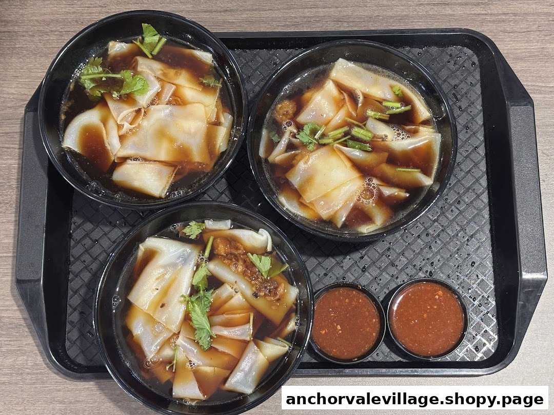Three bowls of traditional Kway Chap with rich broth and two dipping sauces served on a tray.