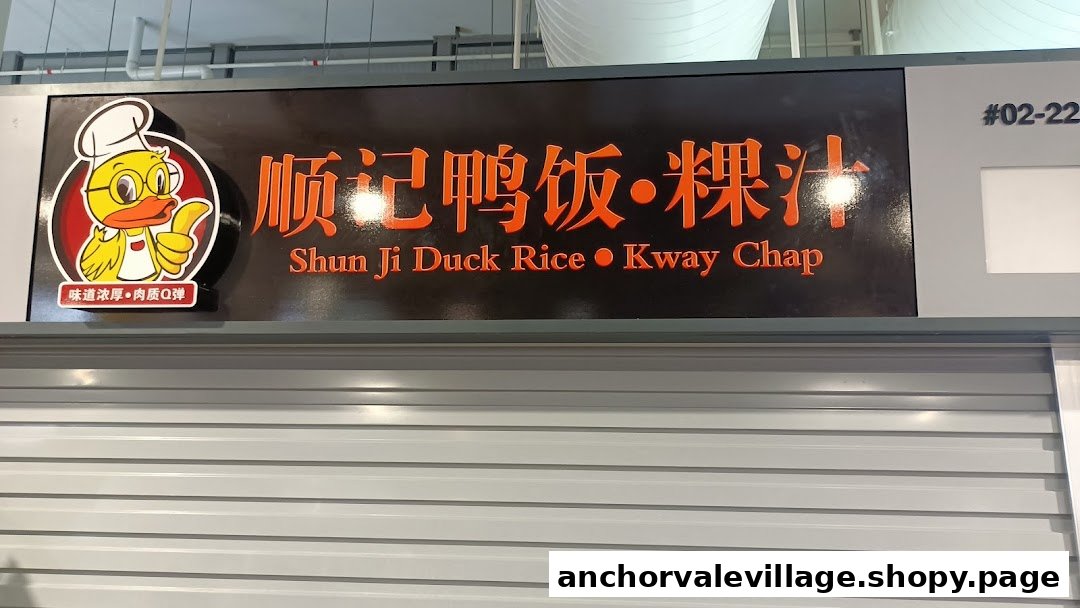 The image displays the signboard for Shun Ji Duck Rice Kway Chap, featuring a chef duck mascot.