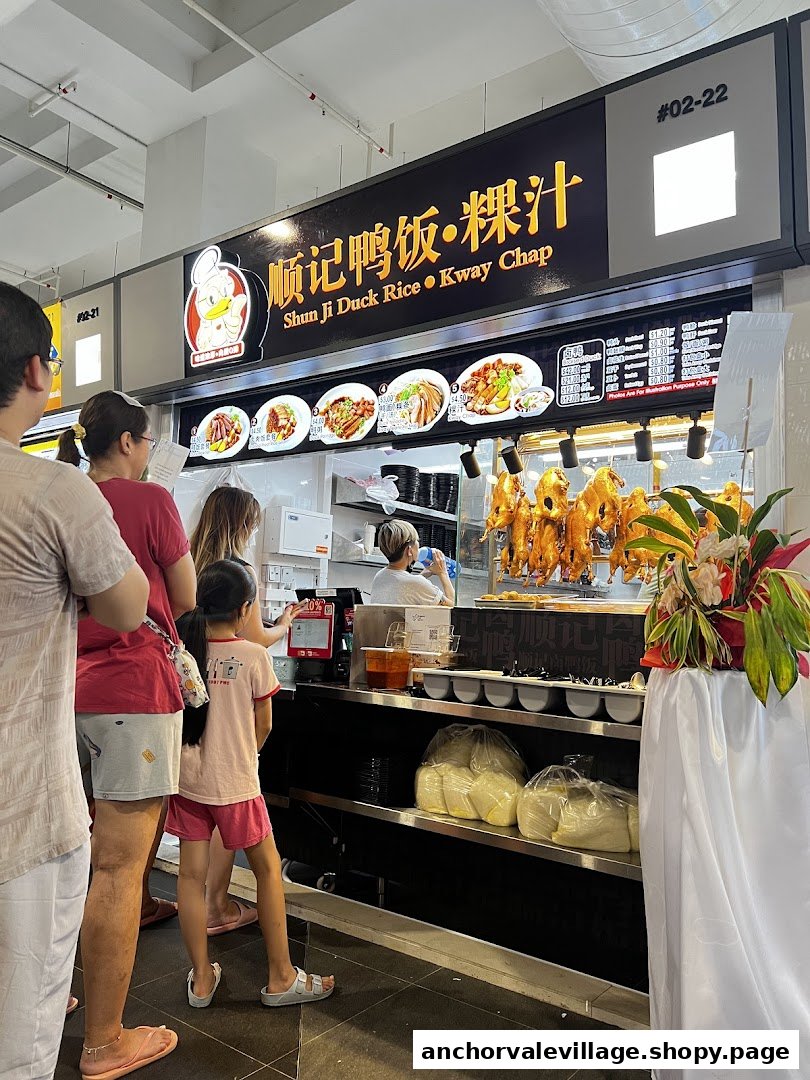 Customers queueing at Shun Ji Duck Rice Kway Chap stall, featuring roasted ducks and a menu board.