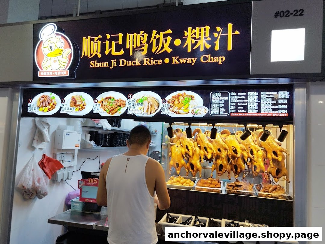 A bustling food stall, Shun Ji Duck Rice Kway Chap, displaying roasted ducks and a detailed menu board.