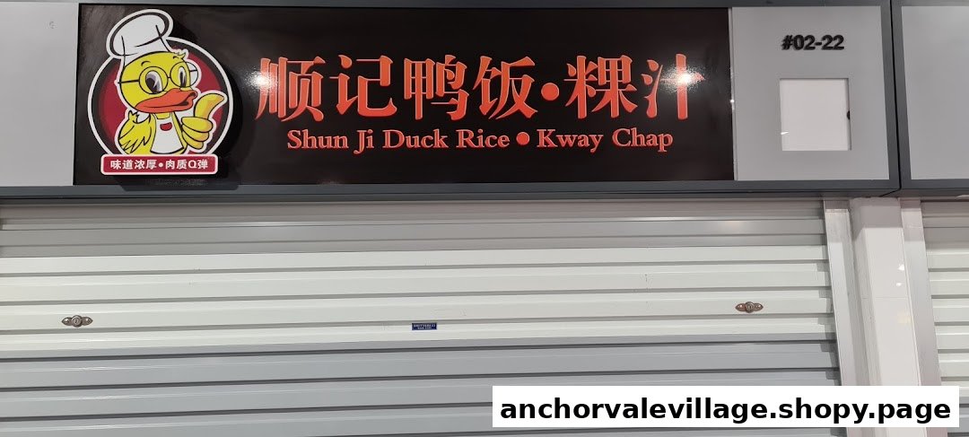 The shopfront of Shun Ji Duck Rice Kway Chap, featuring its signboard and closed roller shutter.