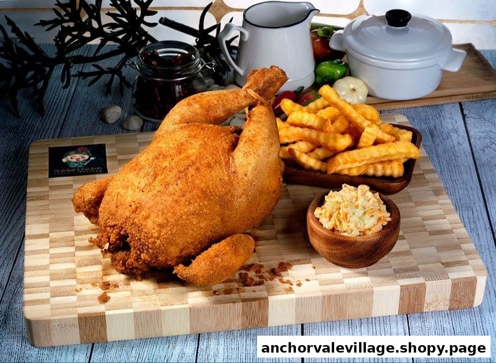 A golden-brown whole fried chicken served with crispy crinkle-cut fries and creamy coleslaw on a wooden board.