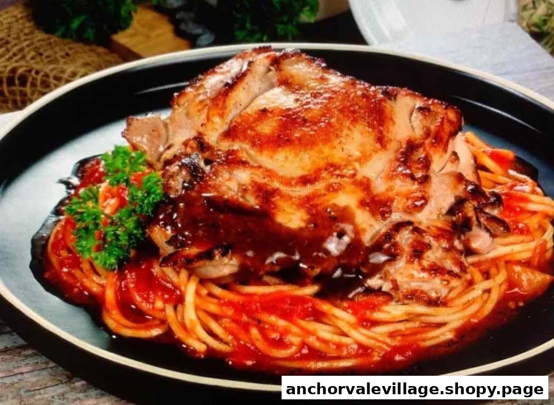A close-up of a grilled chicken chop served over spaghetti with tomato sauce and parsley.