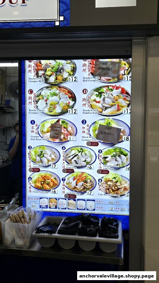 A brightly lit menu board displaying various Teochew-style fish soups and other seafood dishes with prices.