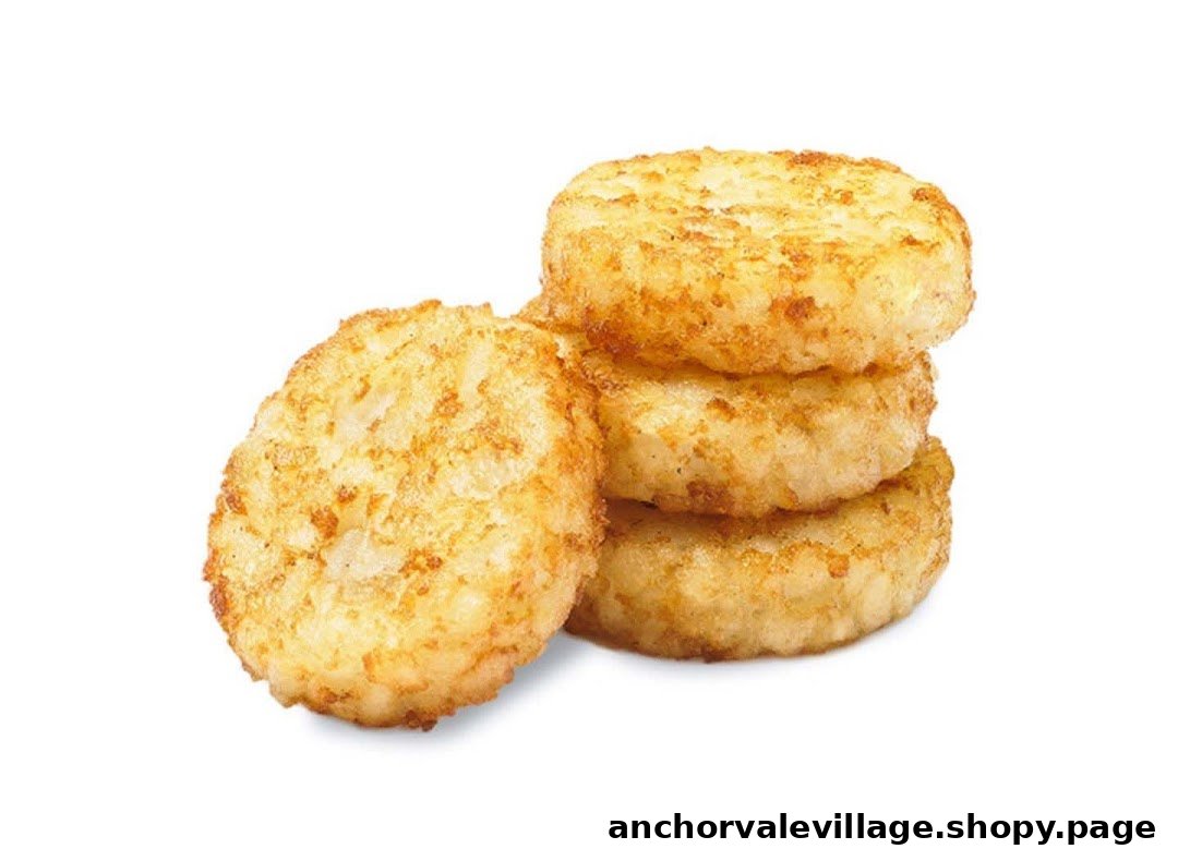 A stack of golden brown, crispy hash browns on a white background.