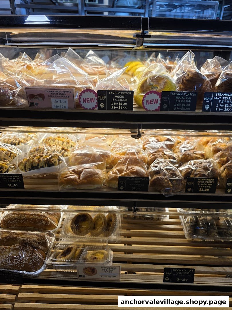 A display case filled with various freshly baked pastries and breads.