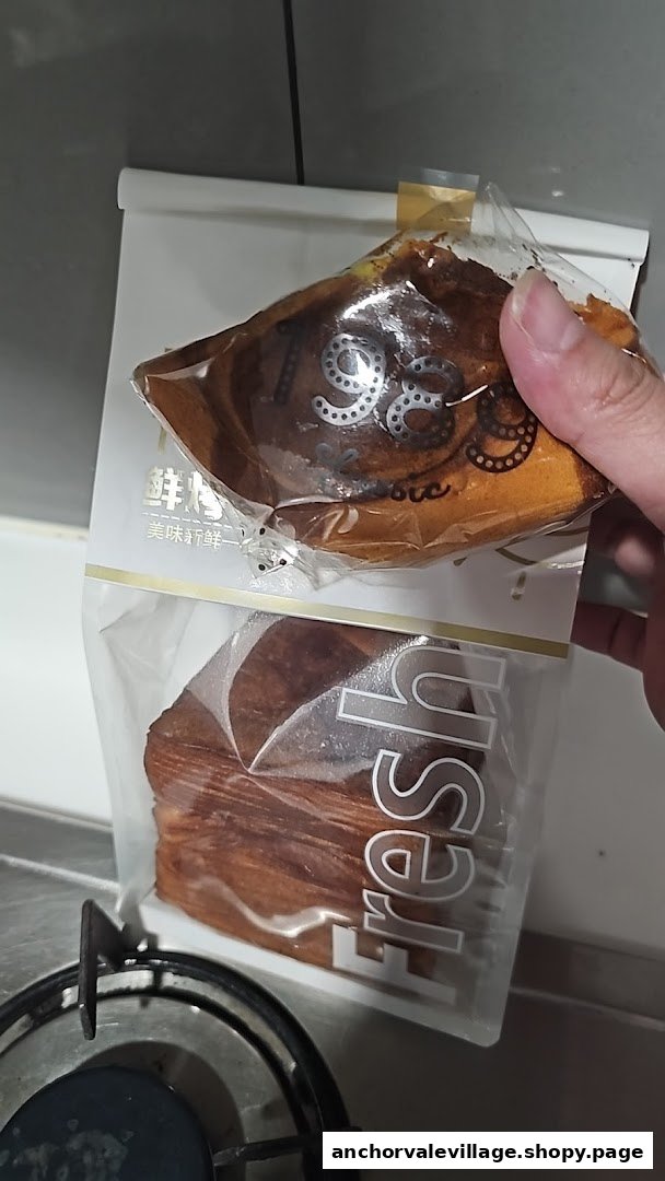 Two packaged baked goods from Swee Heng 1989 Classic, held by a hand.