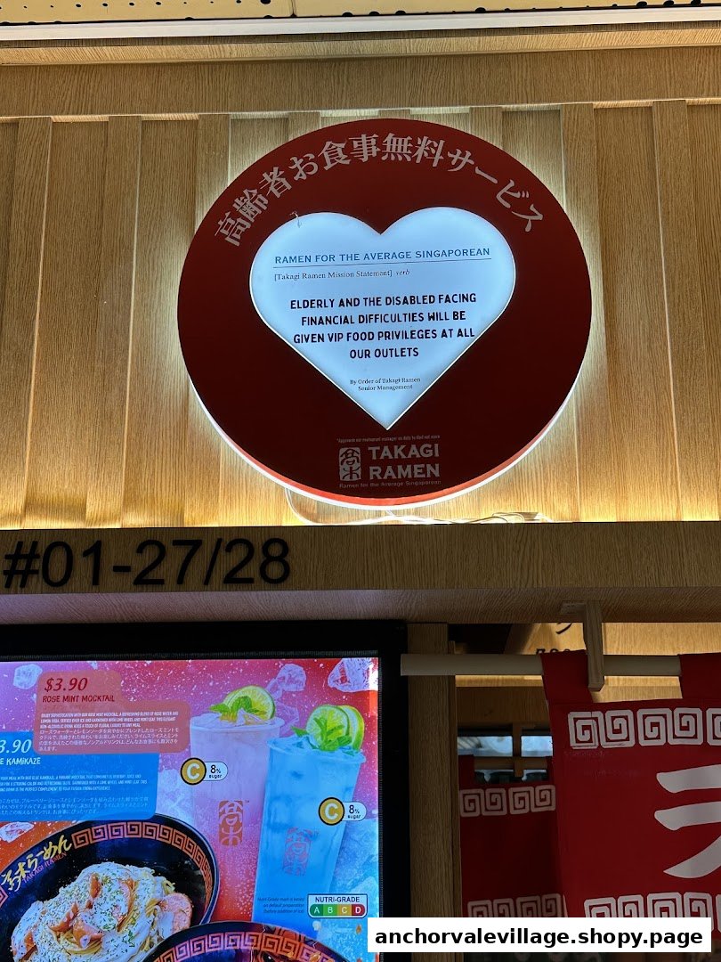 The entrance of Takagi Ramen, featuring a mission statement sign and a partial view of their digital menu board.