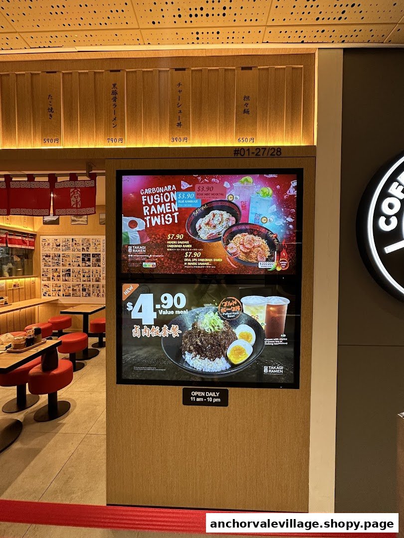 Digital menu displays and traditional wooden panels showcase Takagi Ramen's offerings at its entrance.