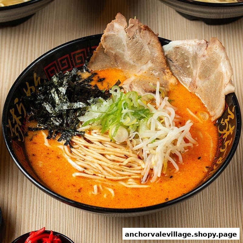 A vibrant bowl of ramen with rich broth, pork slices, seaweed, and fresh vegetables.
