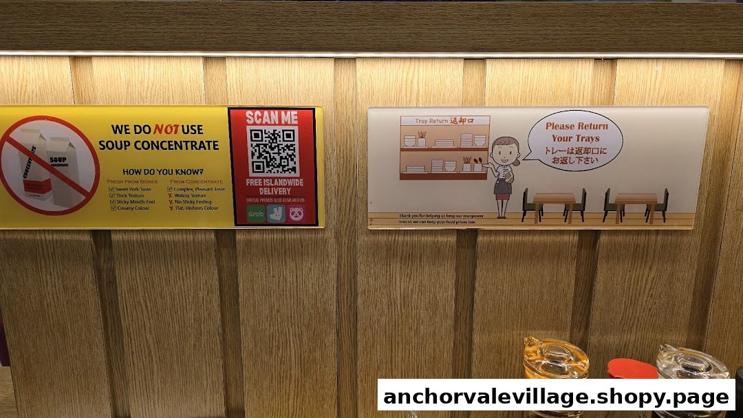 Signs on a wooden wall at Takagi Ramen, highlighting no soup concentrate and tray return policy.